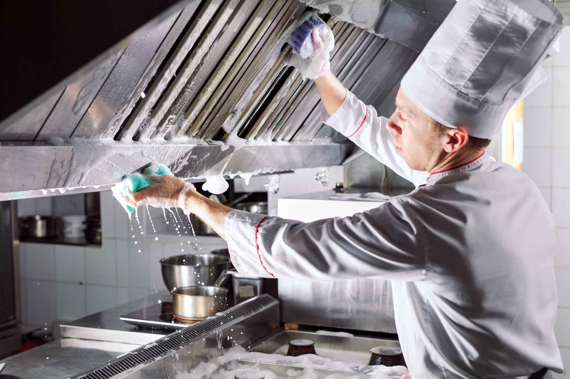Sanitary day in the restaurant. Repeats wash your workplace. Cooks wash oven, stove and extractor in the Restaurant