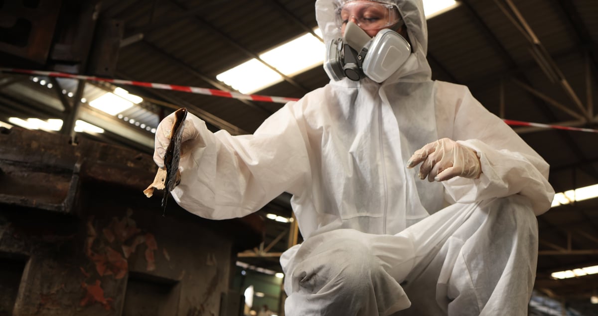 Professional lead paint abatement worker in protective equipment