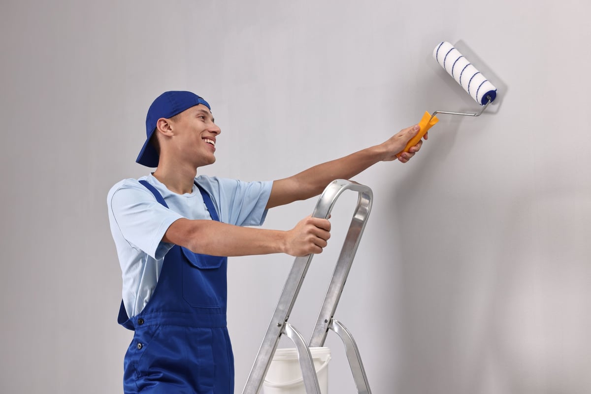 Professional painter painting interior wall